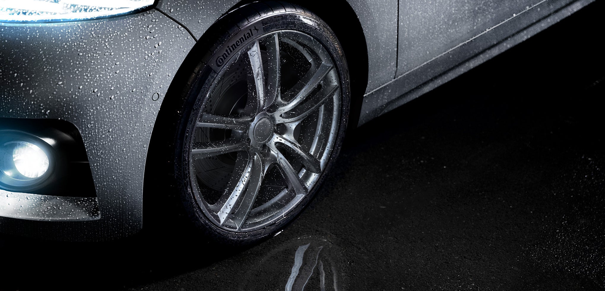Driving in heavy rain Continental Tire shown in a puddle while it is raining.