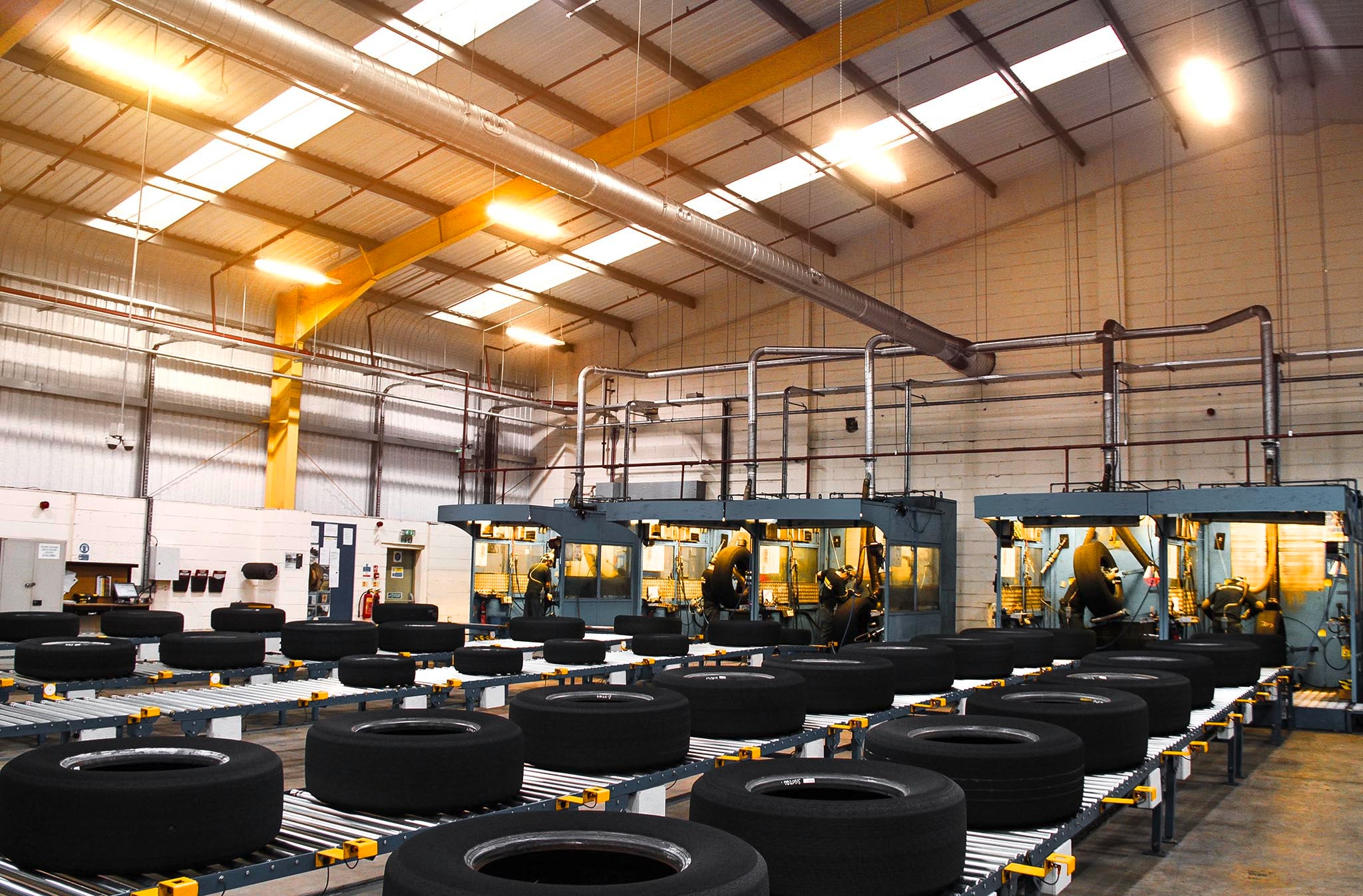Casing Management a lot of tires lying on a conveyor belt in a hall