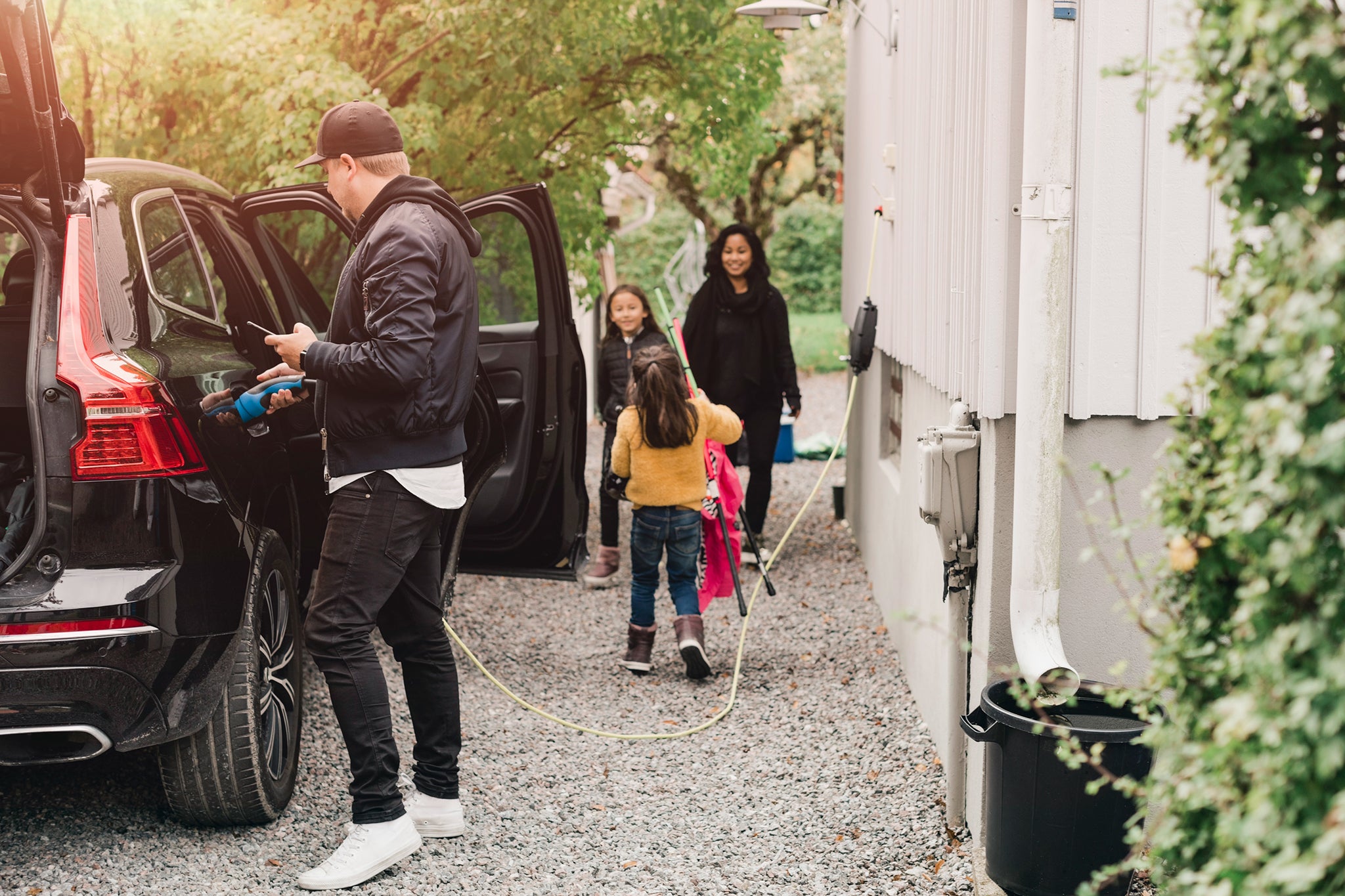 Family preparing their car A family is prepairing their car for the next trip.