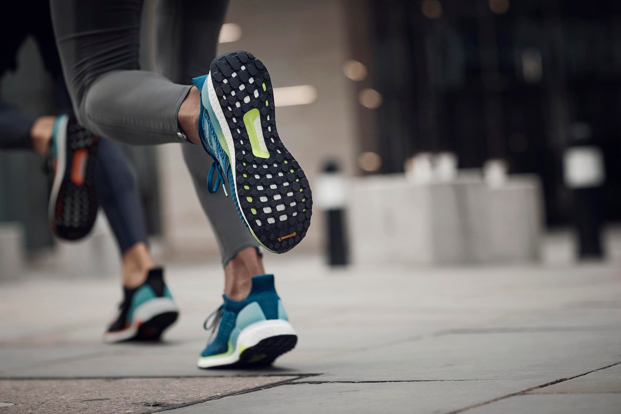 Woman running with Adidas Solarboost sports shoe.