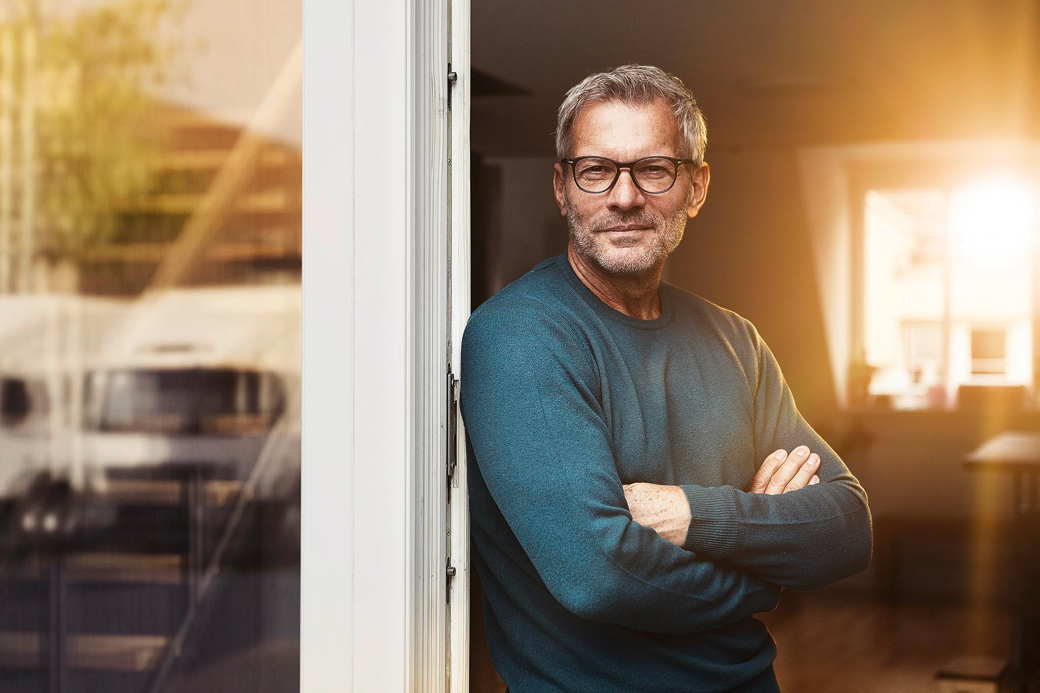 A fleet manager wearing glases at the door of his office