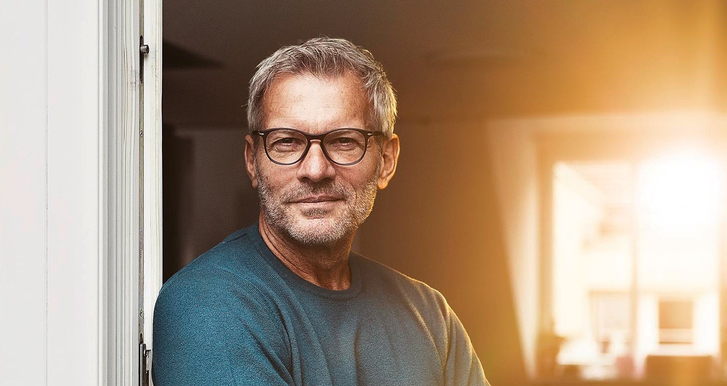 A fleet manager wearing glases at the door of his office