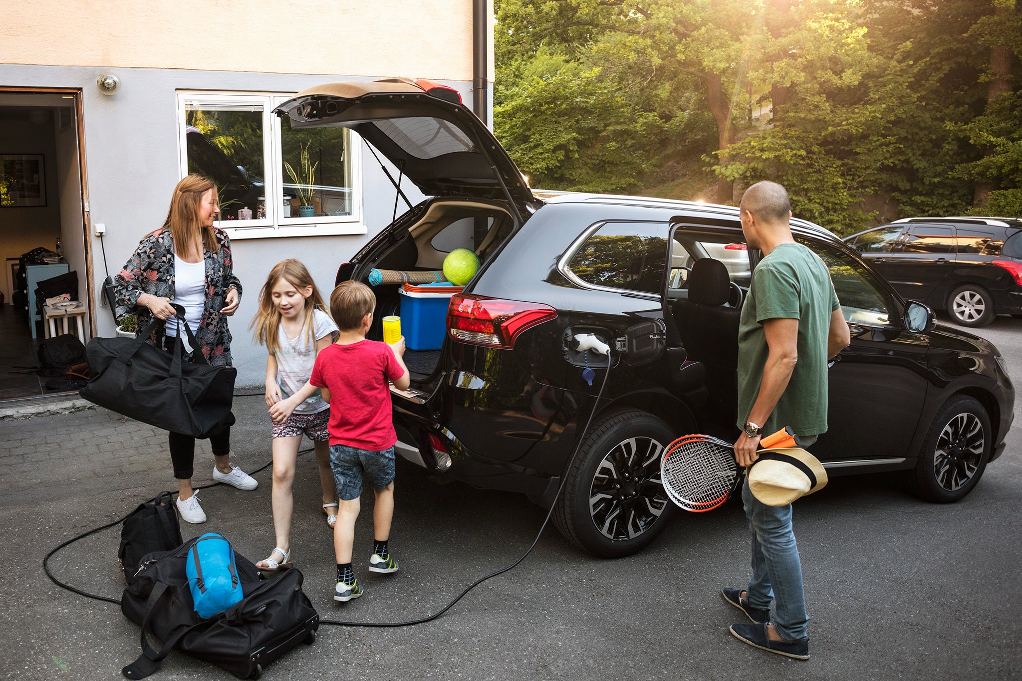 Starting vacations A family is loading their car, ready for holidays.
