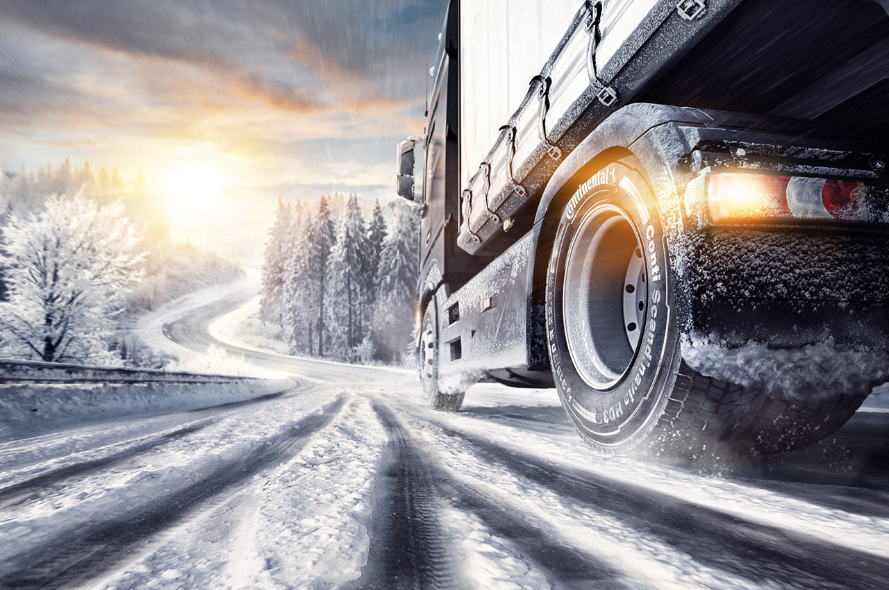 Truck drives on a country road in snow