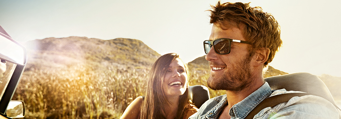 man and woman in convertible