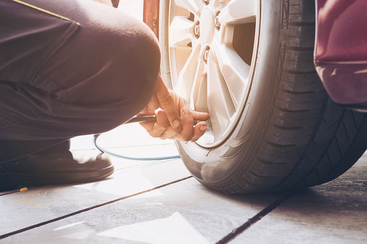 Technician is inflate car tire - car maintenance service transportation safety concept