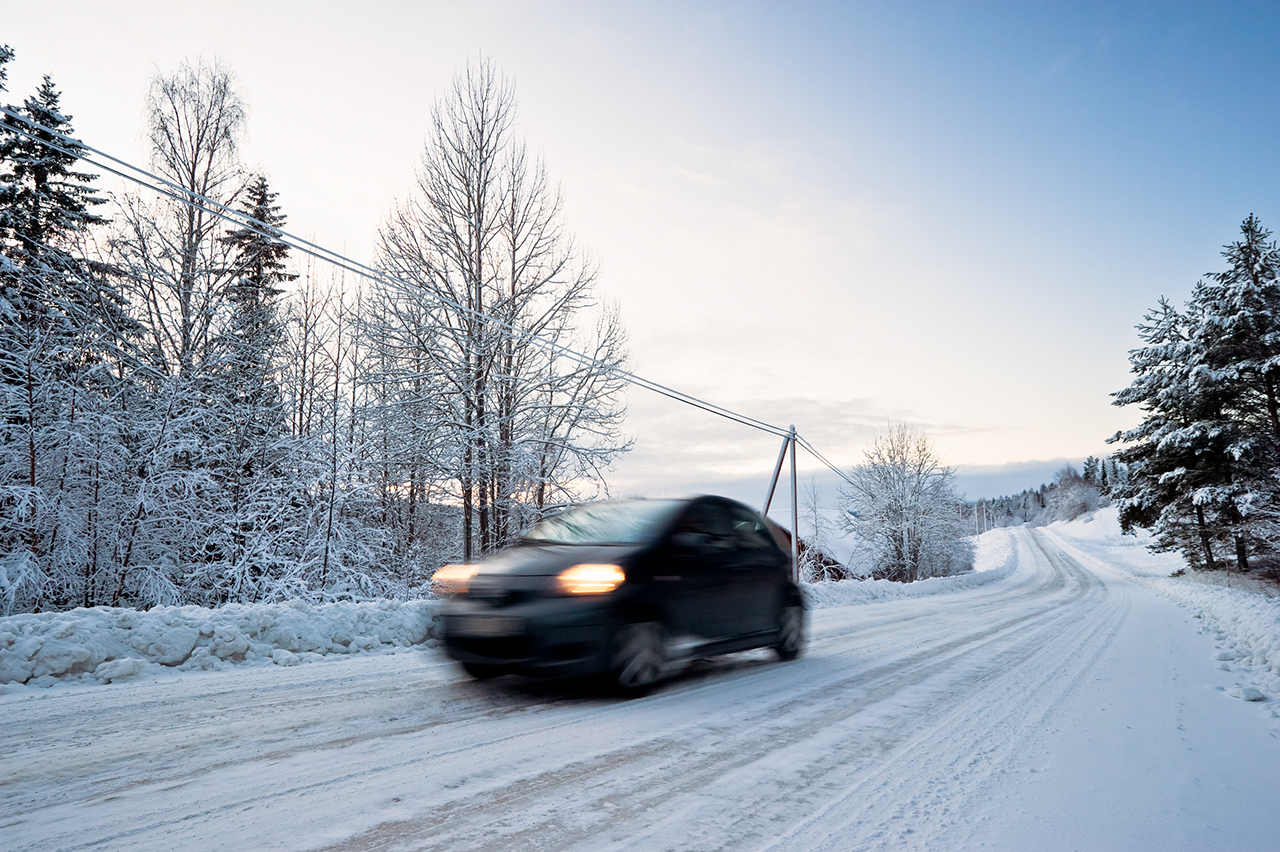 A car driving in winter landscape.