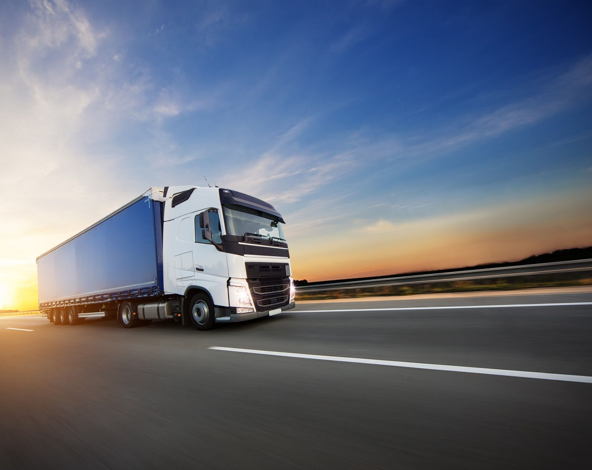 Loaded European truck on motorway in beautiful sunset light. On the road transportation and cargo.; Shutterstock ID 1183131652; Purchase Order: new business; Job: ; Client/Licensee: ; Other: 